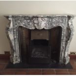 A 19TH CENTURY WHITE AND GREY VEINED MARBLE CHIMNEY PIECE the serpentine shelf with foliate carved