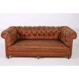 A 19TH CENTURY MAHOGANY AND UPHOLSTERED SETTEE with button upholstered scroll over back and arms