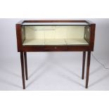 A MODERN MAHOGANY AND GLAZED FREE STANDING SHOP DISPLAY CABINET