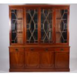 A GEORGIAN DESIGN MAHOGANY FOUR DOOR LIBRARY BOOKCASE the dentil moulded cornice above astragal