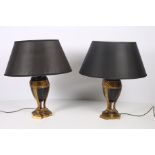 A PAIR OF GILT METAL AND POLYCHROME TABLE LAMPS each decorated with ribbon tied swags on triform