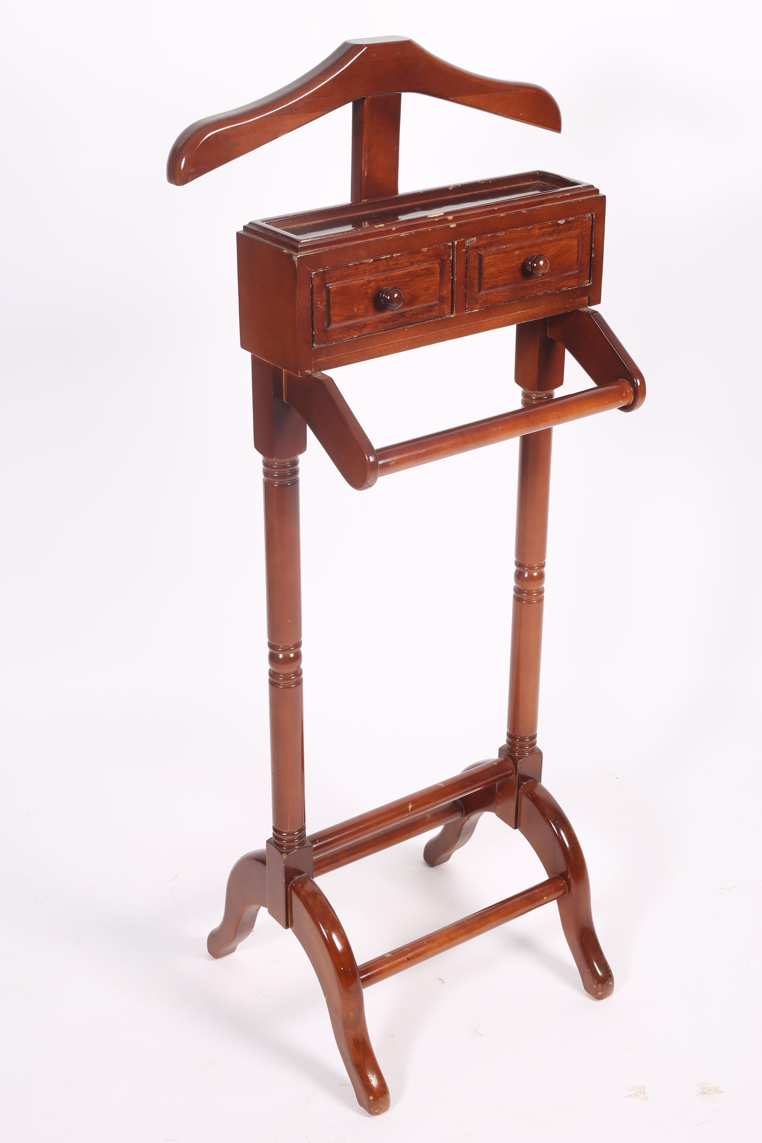 A MAHOGANY VALET of typical form 129cm (h) x 44cm (w) x 42cm (d)