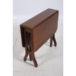AN EDWARDIAN MAHOGANY AND SATINWOOD INLAID SUTHERLAND TABLE the rectangular hinged top raised on