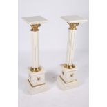 A PAIR OF CONTINENTAL WHITE MARBLE AND GILT BRASS PEDESTALS each with a square stepped top above a