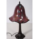 AN ART DECO DESIGN TABLE LAMP the multicoloured glazed shade above a spreading column 53cm (h)