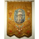 An early 20th century processional banner venerating St. Brigid. A gold silk brocade banner centered
