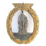 1939-45 German Kriegsmarine Minesweepers Badge. An exploding mine at sea within a gilt oval oak-leaf