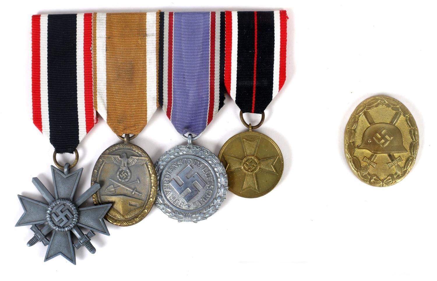 1934-45 German medals, mounted as a group of four and gold wound badge. War Merit Cross, second