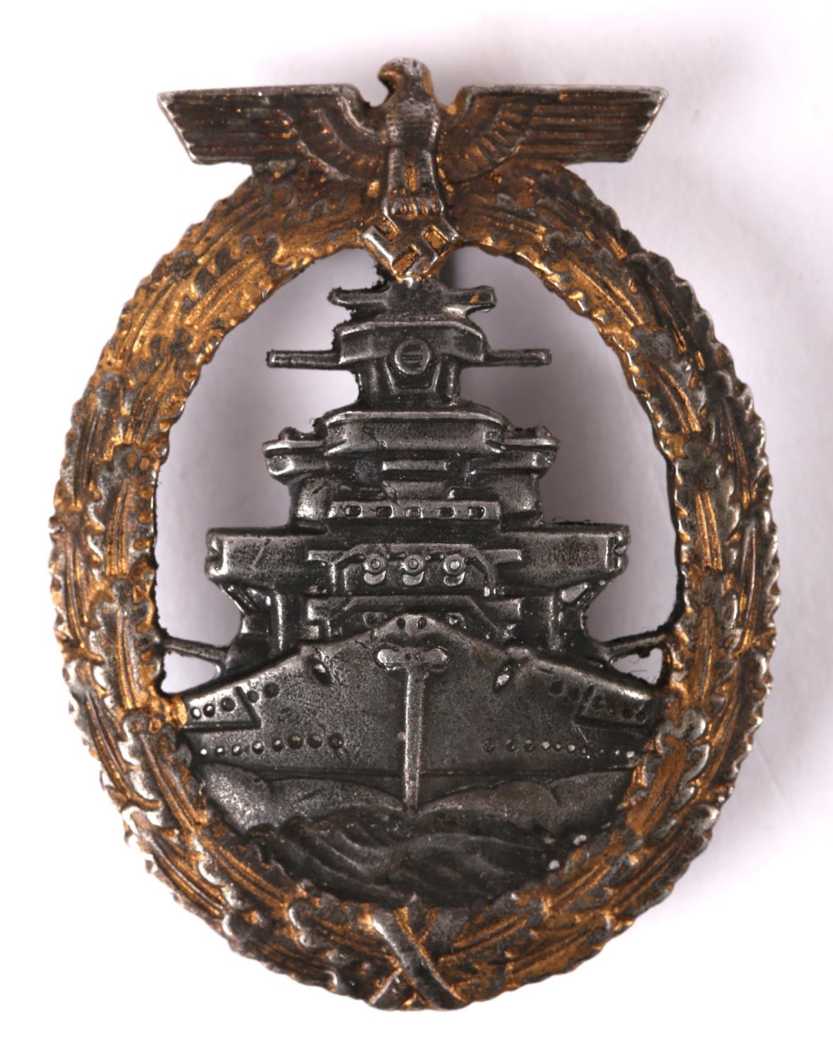 1939-1945 German Kriegsmarine high seas fleet badge. A grey approaching battleship within a gilt