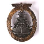 1939-1945 German Kriegsmarine high seas fleet badge. A grey approaching battleship within a gilt