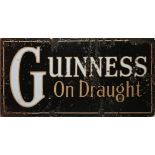 Guinness on Draught. A mid-20th century enamel advertising sign. A rectangular metal one-sided, wall