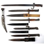 A collection of five bayonets. An early 20th century sword bayonet, a German M1884/98 bayonet, a