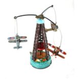 A mid 20th century Chinese, tinplate, clockwork toy, three biplanes circling a tower. This lot is