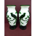 Pair of Chinese green overlay glass vases on a white ground with decoration of birds on a branch -