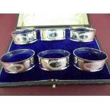 A set of six cased oval silver numbered napkin rings (1-6) - Sheffield 1914 - maker Walker and Hall