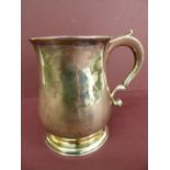 GII silver baluster shaped pint tankard with scroll handle on a raised circular foot - London 1734 -