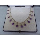 Edwardian 9 ct gold necklace with twelve graduated oval cut amethysts and seed pearls in original