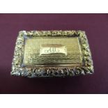 A rectangular silver gilt vinaigrette by Francis Clark with scroll and foliate border in relief to