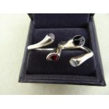 Pair of Georg Jensen Carnival silver rings, set with moonstone and onyx, rock crystal and garnet -