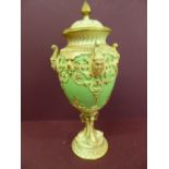 Late 19thC Royal Worcester porcelain urn with cover , flaming finial decoration of pixie masks,