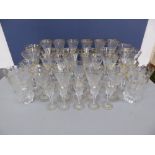 A suite of thirty five good quality cut glasses with gilt and rose decoration