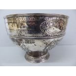 GV chased silver punch bowl with shell, flower and C scroll decoration on a raised circular foot.