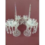 A pair of cut glass twin branch candestick lustres with obelisks to centre drops to each sconce with