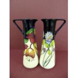 Modern Moorcroft , a pair of tall slender jugs with hibiscus and clover decoration - Ht. 24cm (