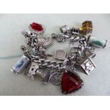 Silver charm bracelet with twenty five charms - 84g