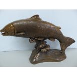 Bronze style composite sculpture of a leaping salmon, signed Elton - length 25 ins.