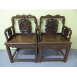 A set of five Chinese carved hardwood ceremonial thrones with shaped tops, circular panel and flat