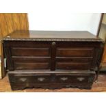 An 18th century oak mule chest / coffer, the cover with moulded egg and dart moulding above panelled