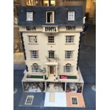 A very large handmade dolls house arranged over five floors, the front opening out to reveal