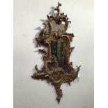 A 19th century Chippendale style finely carved giltwood rococo wall mirror, with scrolling foliage