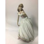 A Lladro porcelain figure of Cinderella 'The Glass Slipper No. 5957', signed to base, 26cm high,