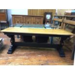 An oak bench / seat with black painted legs and stretcher with carved detail and red and gilt