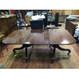 A 19th century mahogany D-ends extending twin pedestal dining table, with solid top with extra
