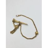 A 9ct yellow gold watch chain with tassle fob, weighing 9.9 grams. (rolled gold seal not included in