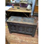 A 17th century stained oak coffer, with carved guilloche, lunette and strapwork decoration to the