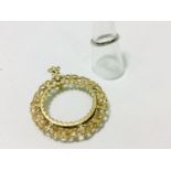 A 9ct yellow gold Kruggerand mount with fluted filigree edging, weighing 10.4 grams. Together with a