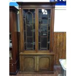 A 19th century mahogany bookcase, of tall narrow proportions, inverted breakfront cornice with