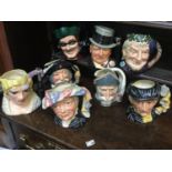 A selection of large Royal Doulton character jugs including Bacchus, Don Quixote, Sancho Panca,