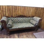 A Victorian stained mahogany sofa, with shaped carved crest rail, and scrolled arms, on reeded front