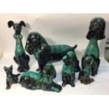 Seven various Canadian Blue Mountain reflowing glazed pottery figures of dogs, the tallest 36cm high