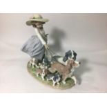 A Lladro porcelain figure group of a young girl walking two spaniels with five puppies in tow, '