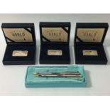 Two Tiffany & Co ballpoint pens with box and suede pouch, together with three 'Wonders of the World'