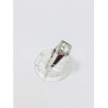 An 18ct white gold solitaire diamond ring set with a round brilliant cut diamond in a square box