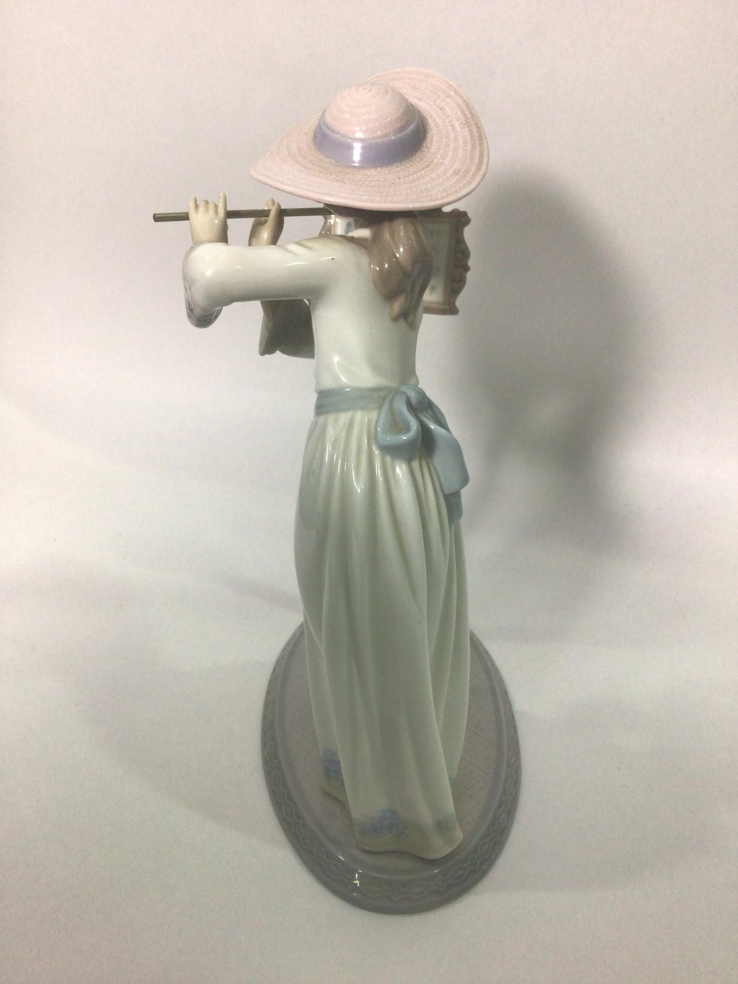 A Lladro porcelain figure of a lady playing the flute, 'Songbird No. 6093', signed to base, 24cm - Image 3 of 5