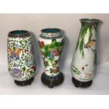 Three various large cloisonné enamel vases on stands, decorated with flowers, birds and