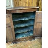 A George III oak hanging corner cupboard, with a pair of raised-and-fielded panel doors with